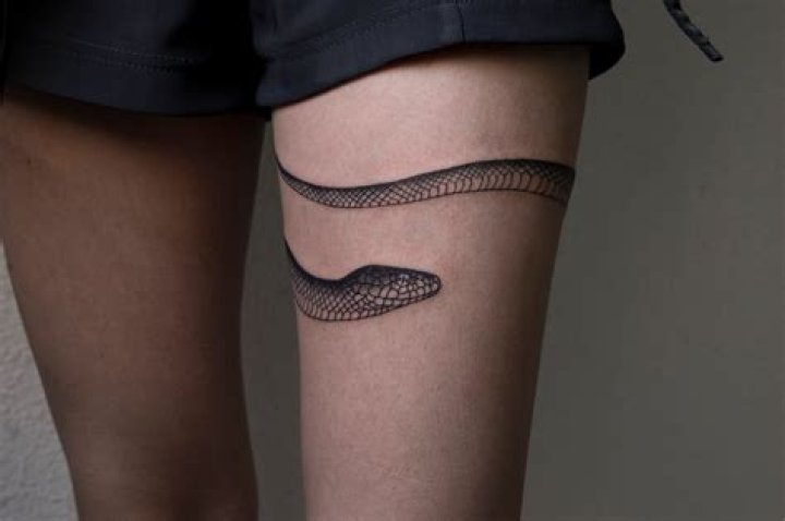 Snake Wrapped Around Thigh Tattoo
